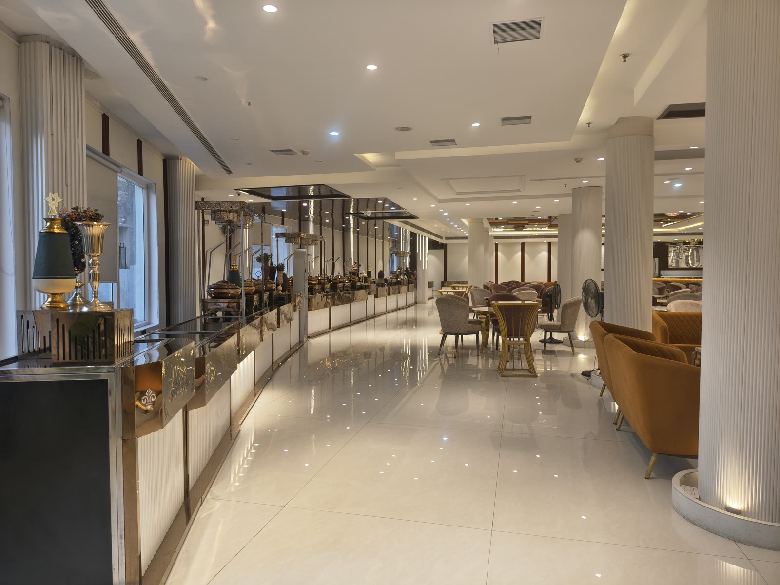 Luxury dining counters with warm lighting and gold filigree at Katani's Sunny Club Kharar