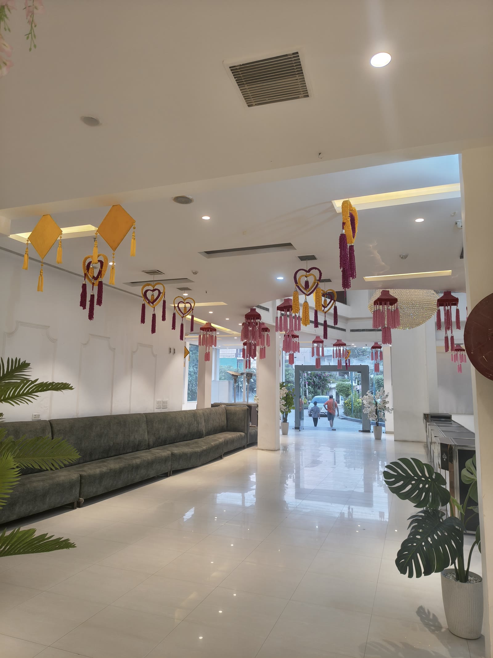Grand entrance lobby with hanging heart decor, festive marigold kites and lounge seating at Katani's Sunny Club Kharar